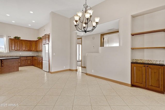 11266 W Calle Con Queso, Casa Grande, AZ 85194 - kitchen featuring freestanding refrigerator, brown cabinetry, decorative light fixtures, a chandelier, and recessed lighting