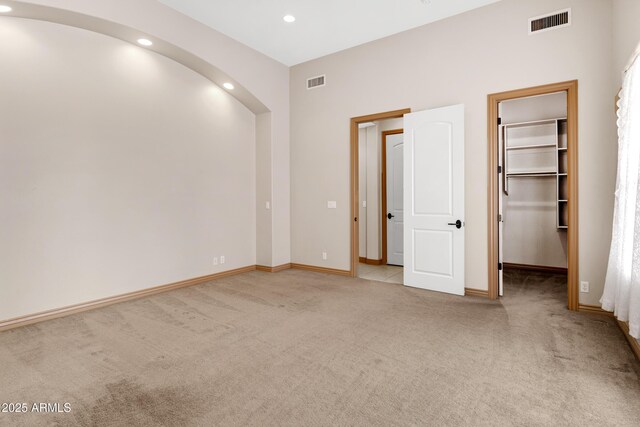 11266 W Calle Con Queso, Casa Grande, AZ 85194 - unfurnished bedroom featuring carpet, recessed lighting, a spacious closet, baseboards, and arched walkways