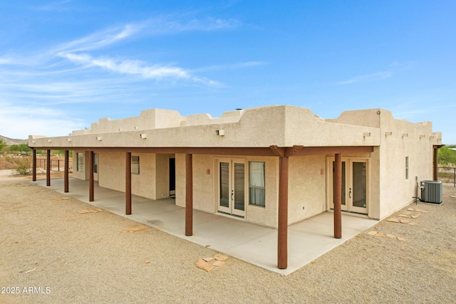 11266 W Calle Con Queso, Casa Grande, AZ 85194 - rear view of property with central air condition unit, stucco siding, french doors, and a patio area