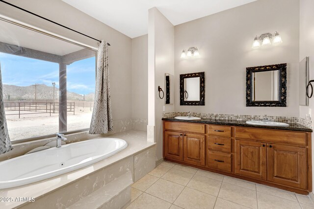11266 W Calle Con Queso, Casa Grande, AZ 85194 - bathroom with a mountain view, tile patterned floors, a bath, and double vanity