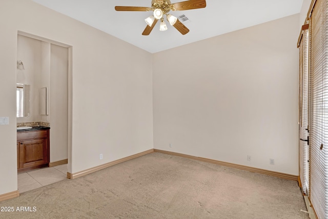 11266 W Calle Con Queso, Casa Grande, AZ 85194 - unfurnished bedroom with light colored carpet, baseboards, multiple windows, and ensuite bathroom