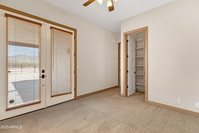 11266 W Calle Con Queso, Casa Grande, AZ 85194 - unfurnished bedroom with carpet floors, baseboards, a walk in closet, and ceiling fan