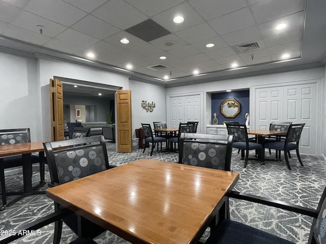 dining room with ornamental molding and carpet