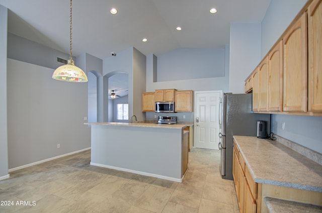 kitchen featuring light brown cabinets, high vaulted ceiling, ceiling fan, appliances with stainless steel finishes, and decorative light fixtures