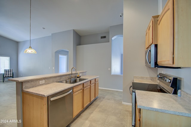 kitchen with light brown cabinetry, stainless steel appliances, sink, light tile patterned floors, and decorative light fixtures