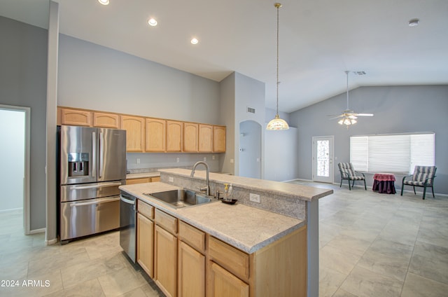 kitchen featuring high vaulted ceiling, a center island with sink, sink, light brown cabinetry, and appliances with stainless steel finishes