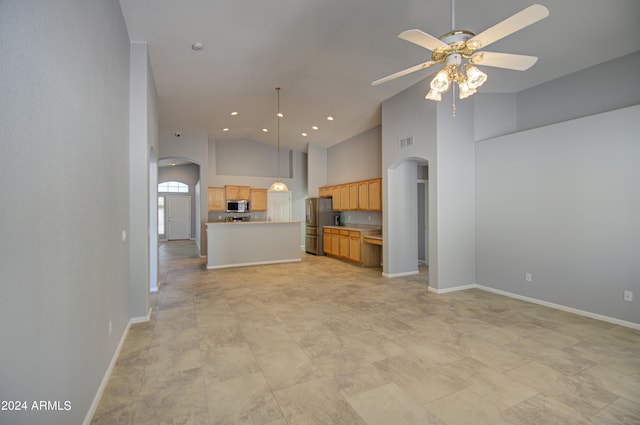 unfurnished living room featuring high vaulted ceiling and ceiling fan