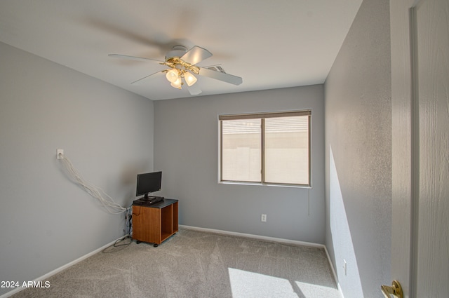 unfurnished room with light colored carpet and ceiling fan