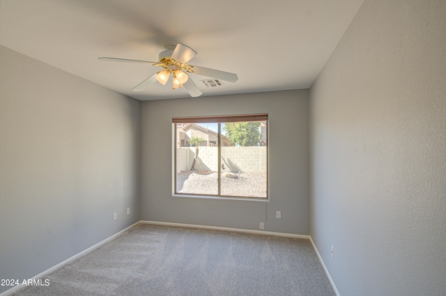 spare room featuring carpet flooring and ceiling fan