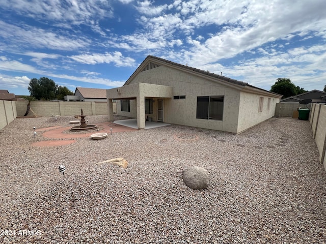 back of property with a patio area