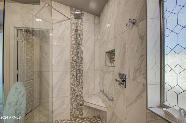 bathroom with tiled shower