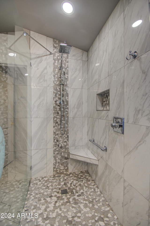 bathroom with tiled shower