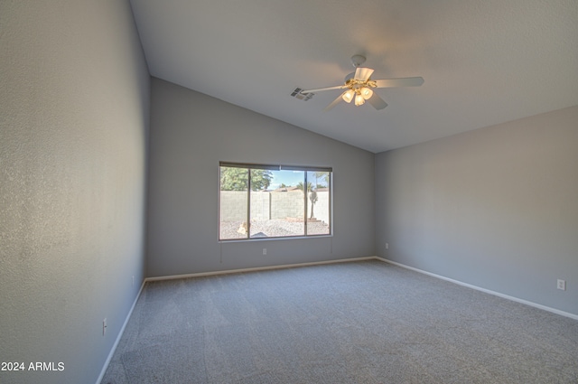 unfurnished room with carpet floors, vaulted ceiling, and ceiling fan