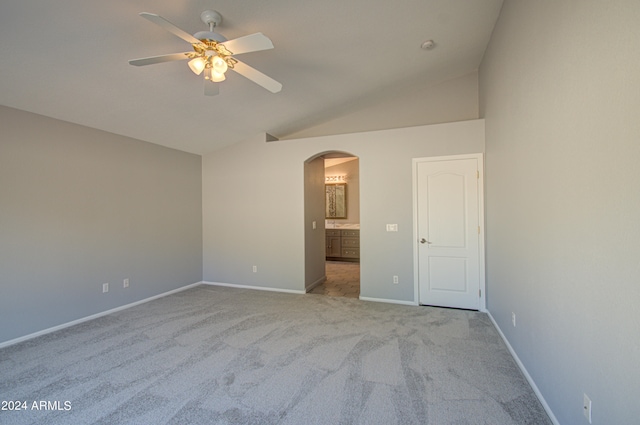 spare room with light carpet, ceiling fan, and lofted ceiling