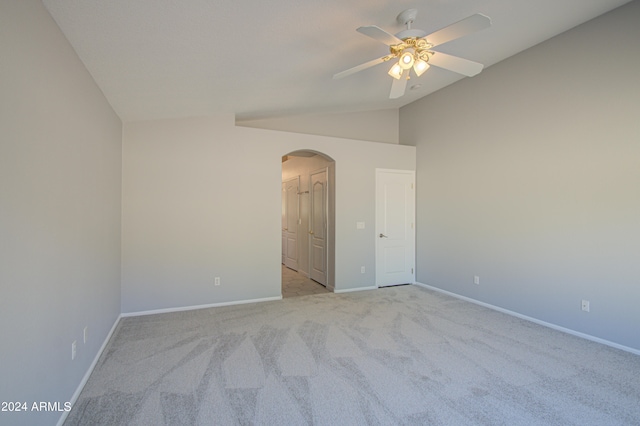 unfurnished room featuring ceiling fan, light carpet, and vaulted ceiling