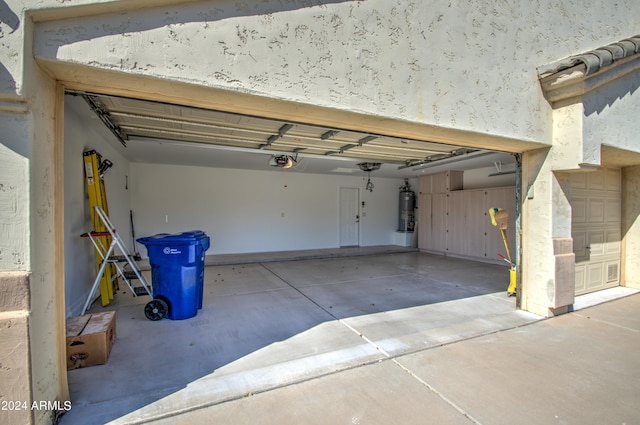 garage featuring a garage door opener and water heater