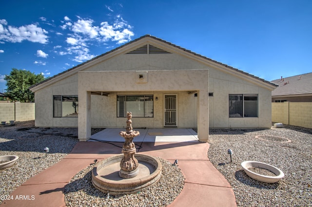 rear view of property featuring a patio