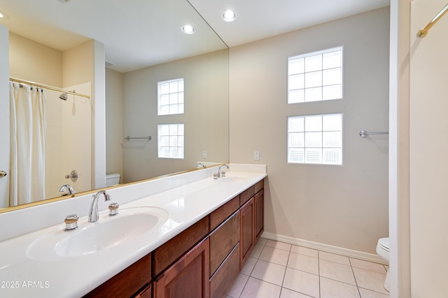 full bath with a sink, baseboards, toilet, and tile patterned floors