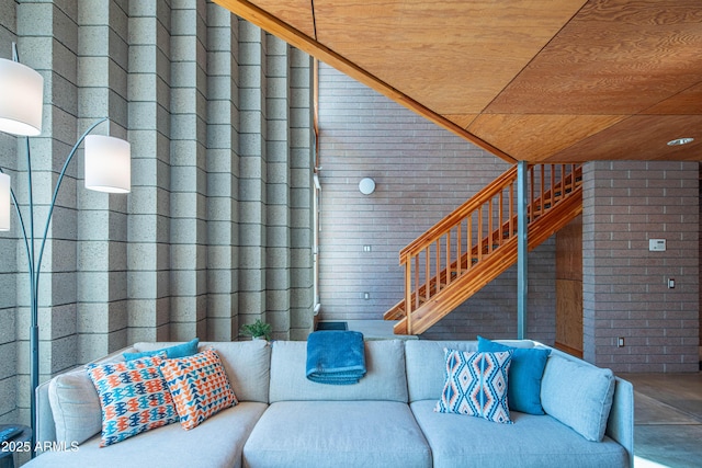 living room with brick wall and wooden ceiling