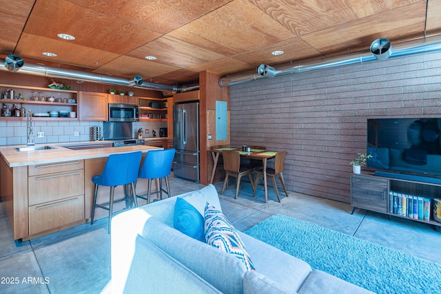 living room with wet bar and wooden ceiling