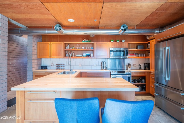 kitchen featuring appliances with stainless steel finishes, wood counters, and open shelves