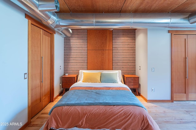 bedroom with baseboards and light wood finished floors