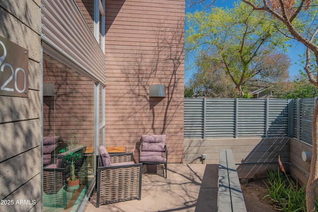 view of patio / terrace featuring fence