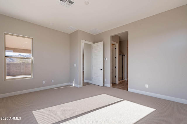 empty room featuring light colored carpet