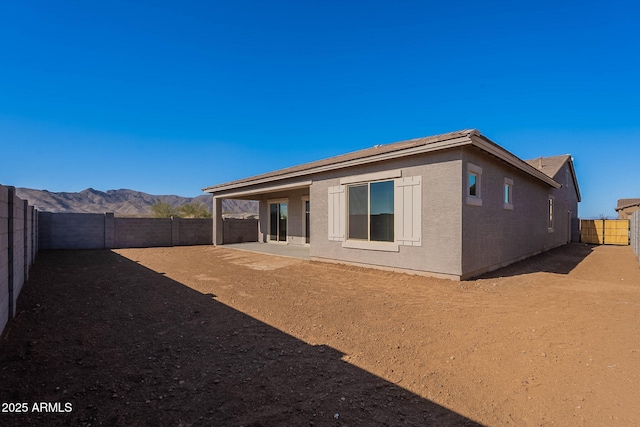 rear view of house featuring a patio and a mountain view