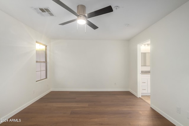 spare room with dark hardwood / wood-style floors and ceiling fan