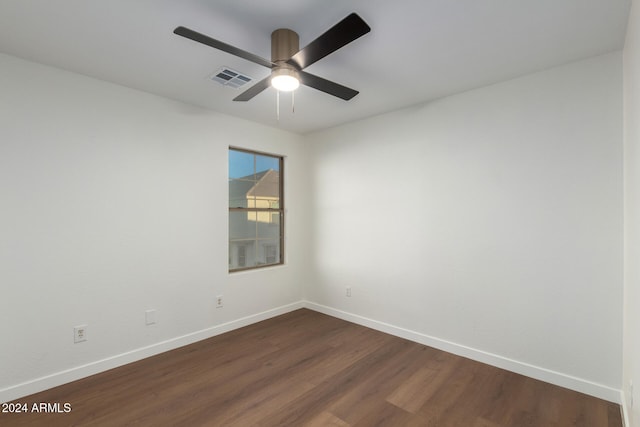 unfurnished room featuring dark hardwood / wood-style floors and ceiling fan