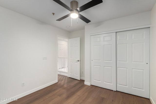 unfurnished bedroom featuring dark hardwood / wood-style flooring, a closet, and ceiling fan