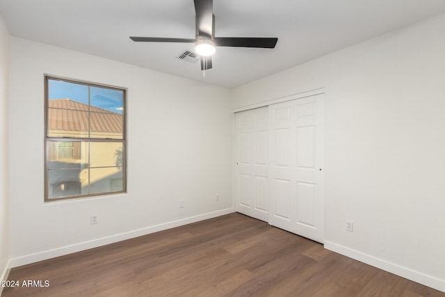 unfurnished bedroom featuring ceiling fan, a closet, and dark hardwood / wood-style floors