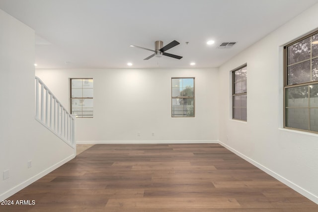 empty room featuring ceiling fan and dark wood-type flooring