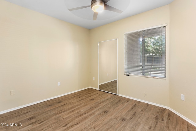 spare room with wood-type flooring and ceiling fan