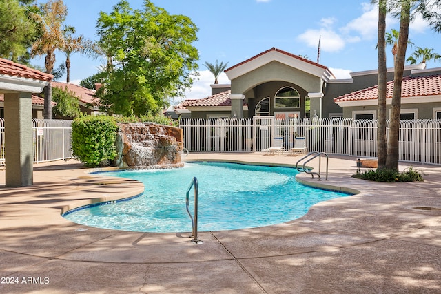 view of pool featuring pool water feature and a patio area