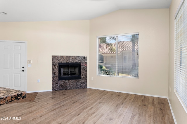 unfurnished living room featuring light hardwood / wood-style flooring and vaulted ceiling