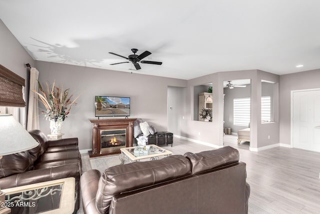 living room with ceiling fan and light hardwood / wood-style flooring