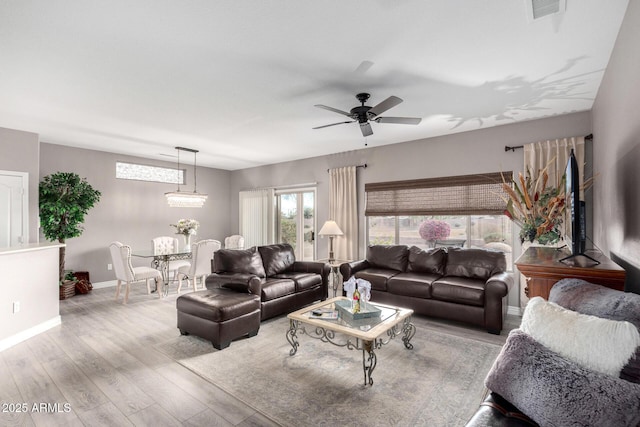 living room with ceiling fan and light wood-type flooring