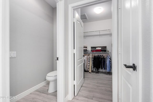 bathroom featuring toilet and hardwood / wood-style floors