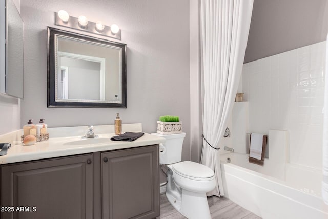 full bathroom with shower / tub combo with curtain, vanity, and toilet