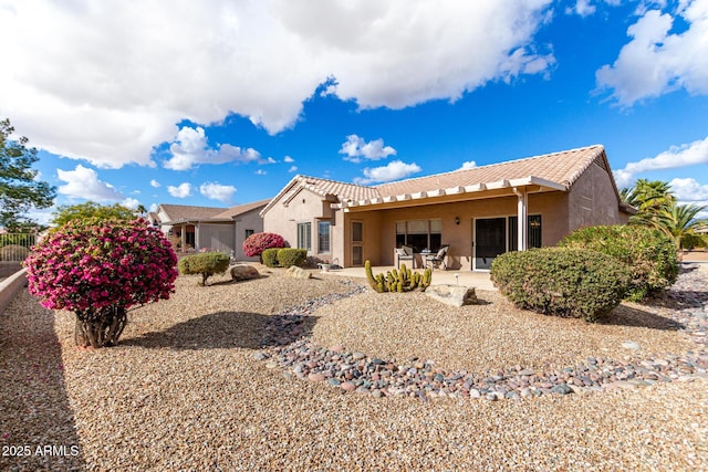 back of property featuring a patio