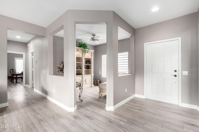 entrance foyer featuring ceiling fan and light wood-type flooring