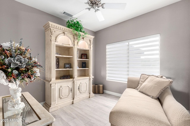 sitting room with ceiling fan and light hardwood / wood-style flooring