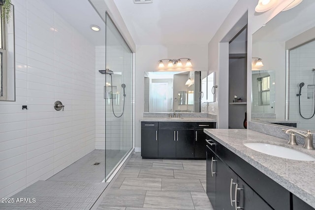 bathroom featuring vanity and a tile shower