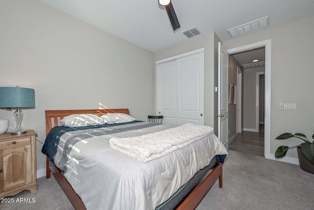 carpeted bedroom featuring a closet and ceiling fan