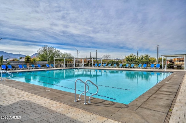 view of swimming pool with a mountain view