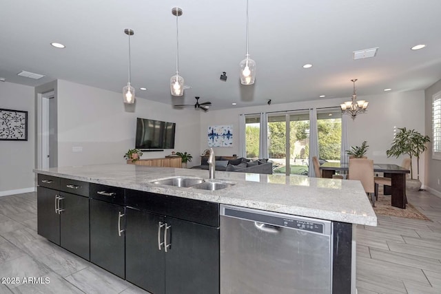 kitchen featuring sink, stainless steel dishwasher, a kitchen island with sink, and hanging light fixtures