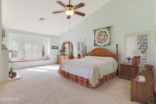 carpeted bedroom featuring ceiling fan and high vaulted ceiling