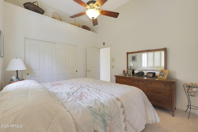 carpeted bedroom featuring ceiling fan, high vaulted ceiling, and a closet